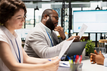 Diverse HR interviewers meeting with an applicant to review CV document, focusing on talent acquisition, work experience and qualifications for employment and onboarding process in enterprise.