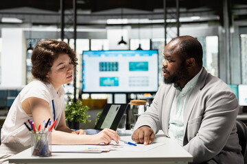 HR specialist hosting a hiring meeting with african american man, reviewing his resume with amazing...