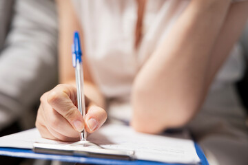Close up of candidate filling in registration forms for job application and interview, ensuring a...