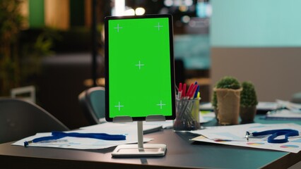 Modern empty boardroom with copy space on tablet and data charts on projections, computer generated...