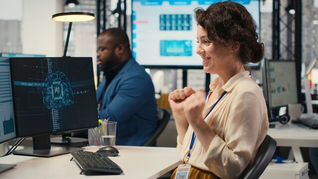 Cheerful businesswoman being proud of good infographics with AI tools, using artificial intelligence for optimization and goals achievement in a multinational company. Neural networks. Camera B.