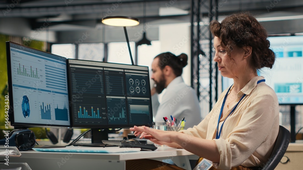 Poster administrator engages with financial data insights on a computer, developing innovative business sol