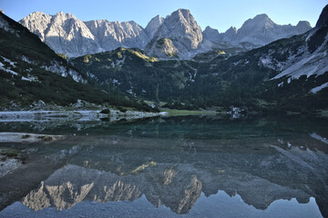 Fototapeta premium Picturesque view of the Mieming Range in Austria. Sunny day, alpine peaks, and serene mountain landscape.