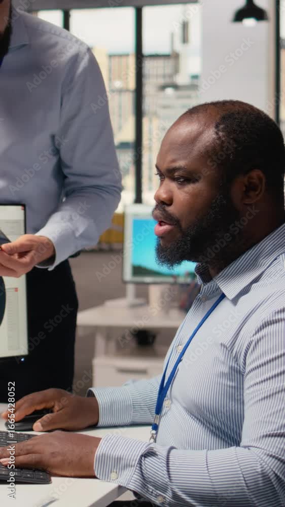 Poster manager overseeing engineer using cad app to optimize wind turbine design, reducing carbon footprint