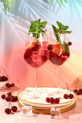 Aperol spritz with cherry, mint, ice with tequila, vodka on elegant background, still life with drinks, minimalist concept for bar, soft and alcoholic drink for weight loss