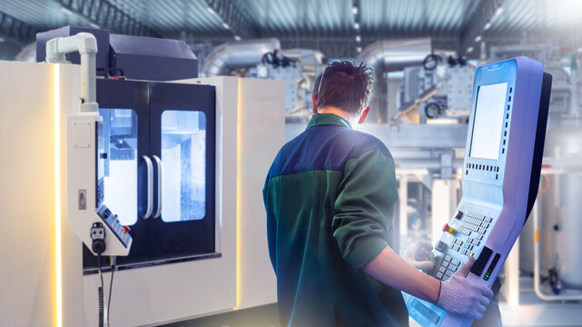 Engineer operates CNC machine with digital control panel in modern factory, concept of automation, precision engineering, manufacturing, industry 4.0. Manufacturing, Engineering, Automation.
