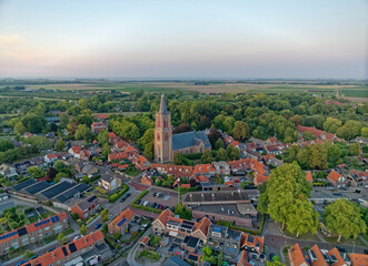 Typical Dutch church Geerteskerk in small town Kloetinge aerial view