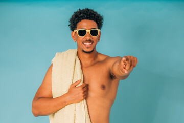 young man with sunglasses in swimming trunks in summer isolated on background