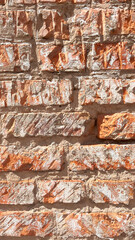 Textured orange and gray brick wall showcasing varying stone patterns and natural colors