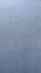 Textured concrete wall with subtle variations in color and pattern observed during daylight hours