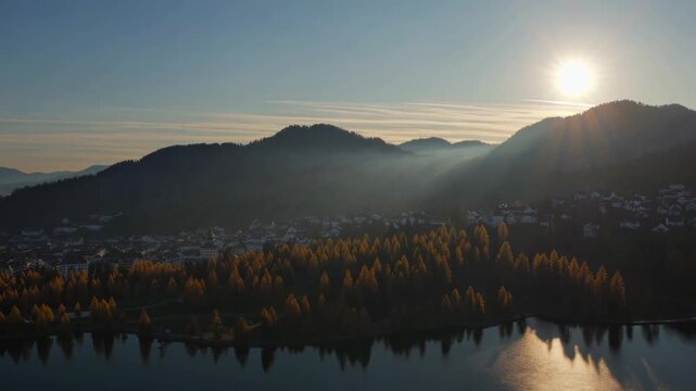 Serene Sunrise Over the Engadin Valley with Misty Mountains and a Calm Lake Reflecting the Morning Light, Captured in Zurich and Engadin, Switzerland