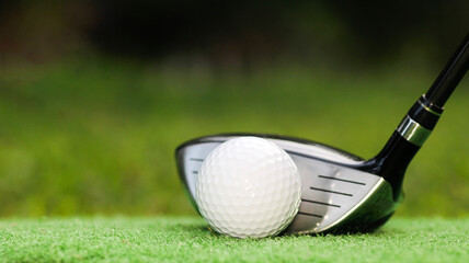 Close-Up of Golf Driver and White Golf Ball on Green Grass Surface
