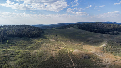 Aerial Scenic Mountain Landscape in Peter Sinks, Utah – Alpine Meadows, Rocky Hills, and Pine...
