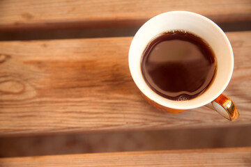 Coffee on wooden table on summer