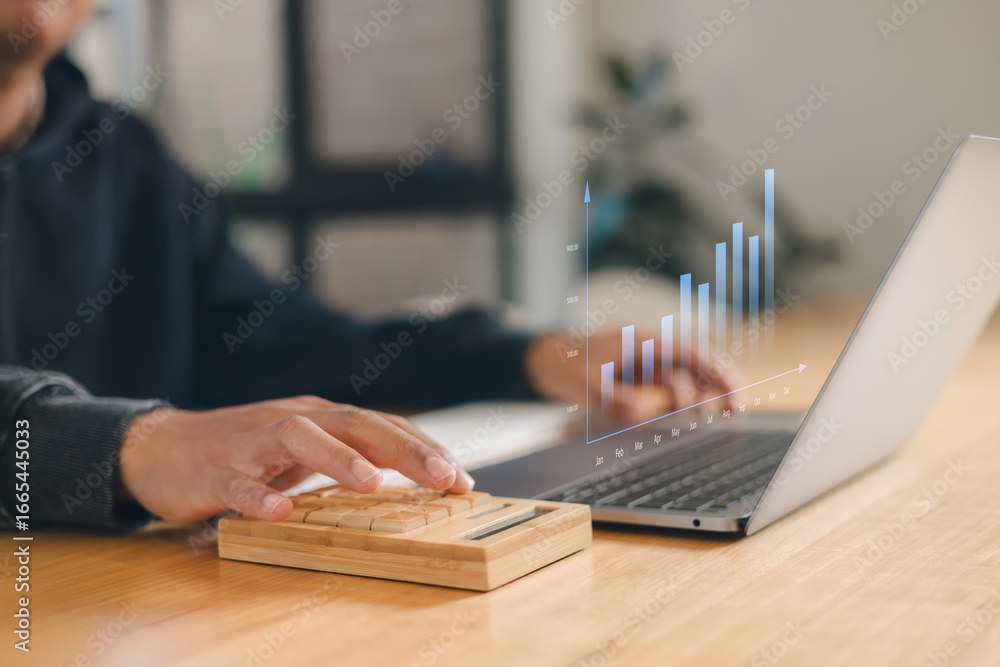 Poster business analyst using laptop and calculator with futuristic financial graph interface, showing grow