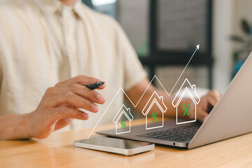 Real estate investment growth concept with businessman showing thumbs up and rising house...