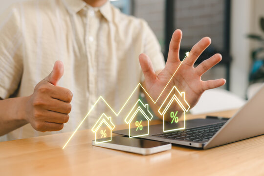 Real estate investment growth concept with businessman showing thumbs up and rising house percentage graph, symbolizing property market success, mortgage rates and financial planning strategy.