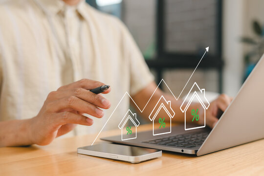 Real estate investment growth concept with businessman showing thumbs up and rising house percentage graph, symbolizing property market success, mortgage rates and financial planning strategy.