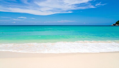 A tranquil beach scene showcases a vibrant turquoise ocean gently lapping at a pristine white sand shore under a vast, cerulean sky adorned with fluffy white clouds.