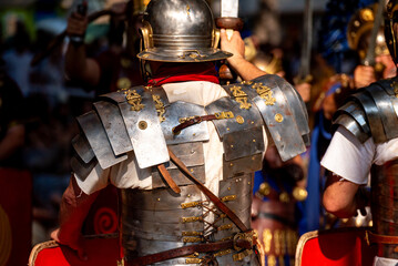 Fototapeta premium A powerful shot of Roman soldiers from behind in full armor.