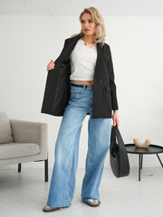 Stylish Model Showcasing a Trendy Outfit in a Modern Indoor Space with a Chic Black Blazer, Casual...