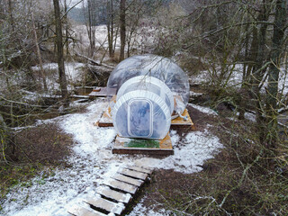 Transparent Bubble Tent on Wooden Platform in Snowy Forest, Belarus