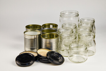 Metal and glass containers stacked for recycling because they are no longer used on a daily basis,...