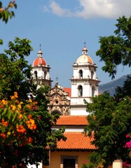 Colonial church towers framed by trees