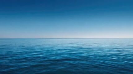 Obraz premium Calm Blue Ocean Surface Under Clear Sky with Gentle Waves and Smooth Horizon at Sunrise or Sunset