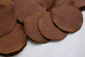 Fermented soybean discs, known as “Thua Nao,” a traditional Thai seasoning used to enhance flavor in Northern cuisine.