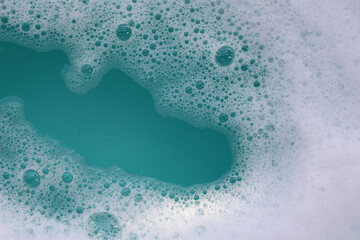 Foamy blue water surface with bubbles.