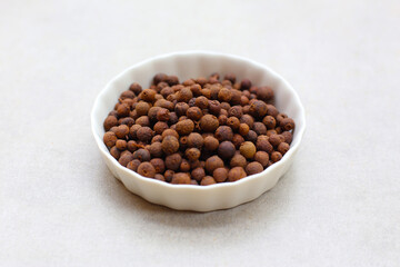 Brown dried allspice spice seeds.