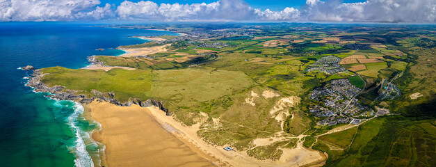 Aerial daytime view of Holywell Bay beach with Gull Rocks in Cornwall, UK