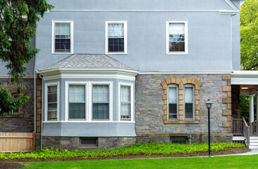 Traditional home exterior with bay window and stone-stucco facade in Boston, Massachusetts, USA
