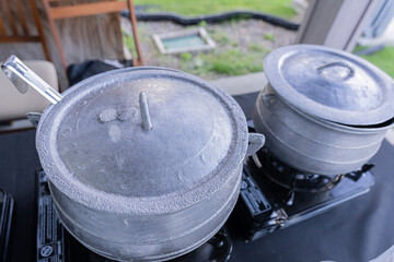 Nigerian cooking pots at a party buffet
