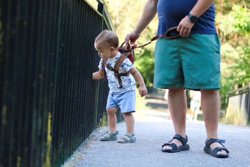 Toddler exploring a bridge with adult supervision