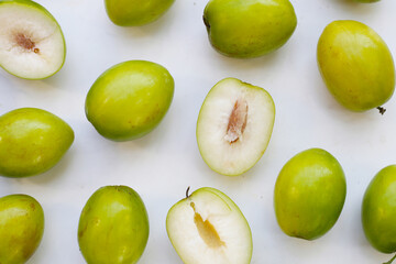 Green jujube fruits on white background.