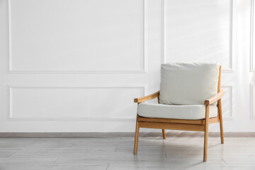 Comfortable armchair near white wall indoors, space for text