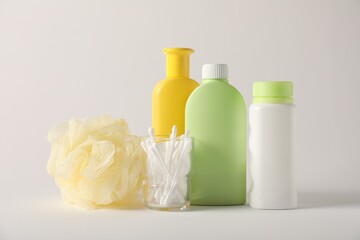 Baby accessories and body care products on light grey background