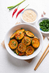 Korean cucumber salad (Oi muchim) in bowl on white background, Korean side dish