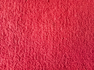 Close up view, Red carpet texture background, wool fabric texture with fiber pattern, as a design object for textile industry product catalog.