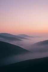 Fototapeta premium Rolling Fog Over Hills at Dawn