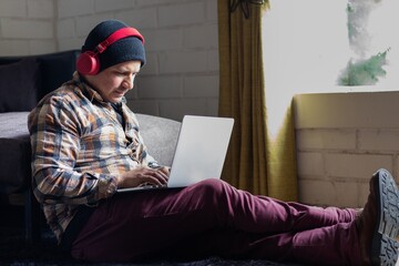 Man sitting on the floor working on his computer