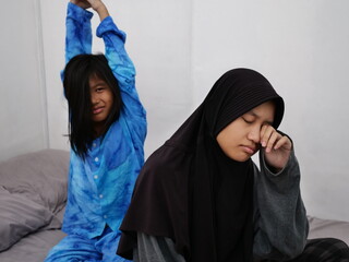 Asian muslim girls siblings just waking up from sleep