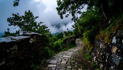 A winding stone path meanders through lush vegetation, past ancient stone walls, under a cloudy sky, evoking a sense of tranquility and history.