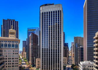Fototapeta premium An aerial view down busy Market and California Street with towering iconic skyscrapers, a quintessential cityscape of San Francisco in California