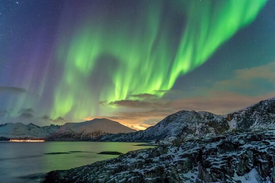 Tromso Norway, aurora borealis northern lights winter landscape at Rorvikneset Sommaroy - Powered by Adobe