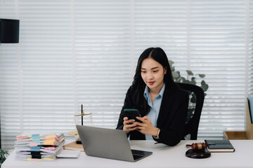 Attractive young lawyer in office Business woman and lawyers discussing contract papers with brass...