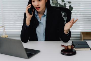 Attractive young lawyer in office Business woman and lawyers discussing contract papers with brass...