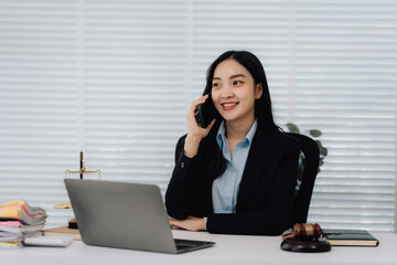Attractive young lawyer in office Business woman and lawyers discussing contract papers with brass...